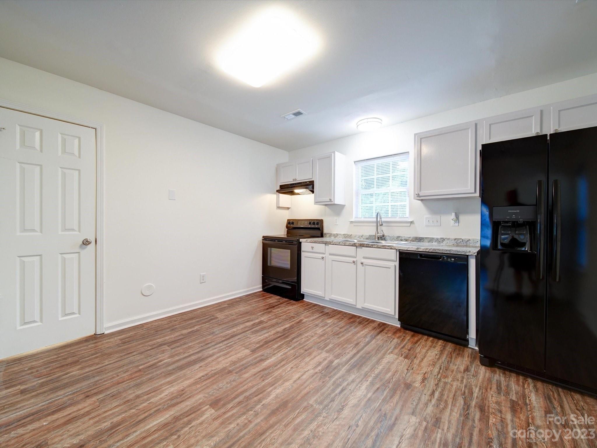 925 Key Street Charlotte, NC 28208 - Photo 16 of 41 a kitchen with a sink wooden floor and stainless steel appliances