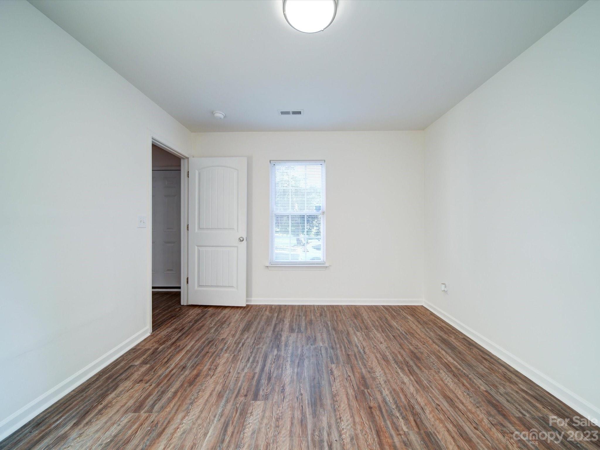 925 Key Street Charlotte, NC 28208 - Photo 17 of 41 a view of a room with wooden floor and white walls