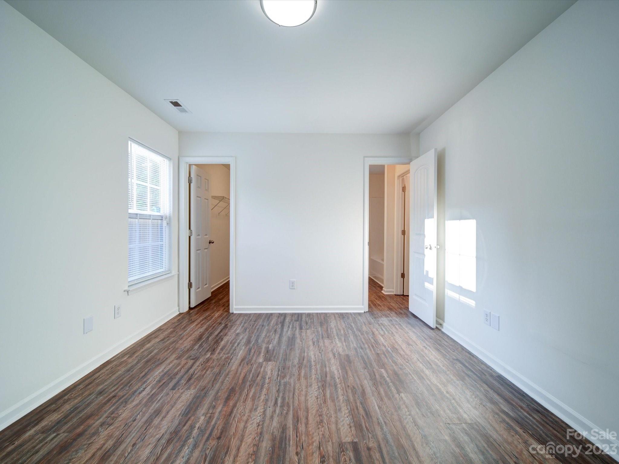 925 Key Street Charlotte, NC 28208 - Photo 19 of 41 an empty room with wooden floor and windows