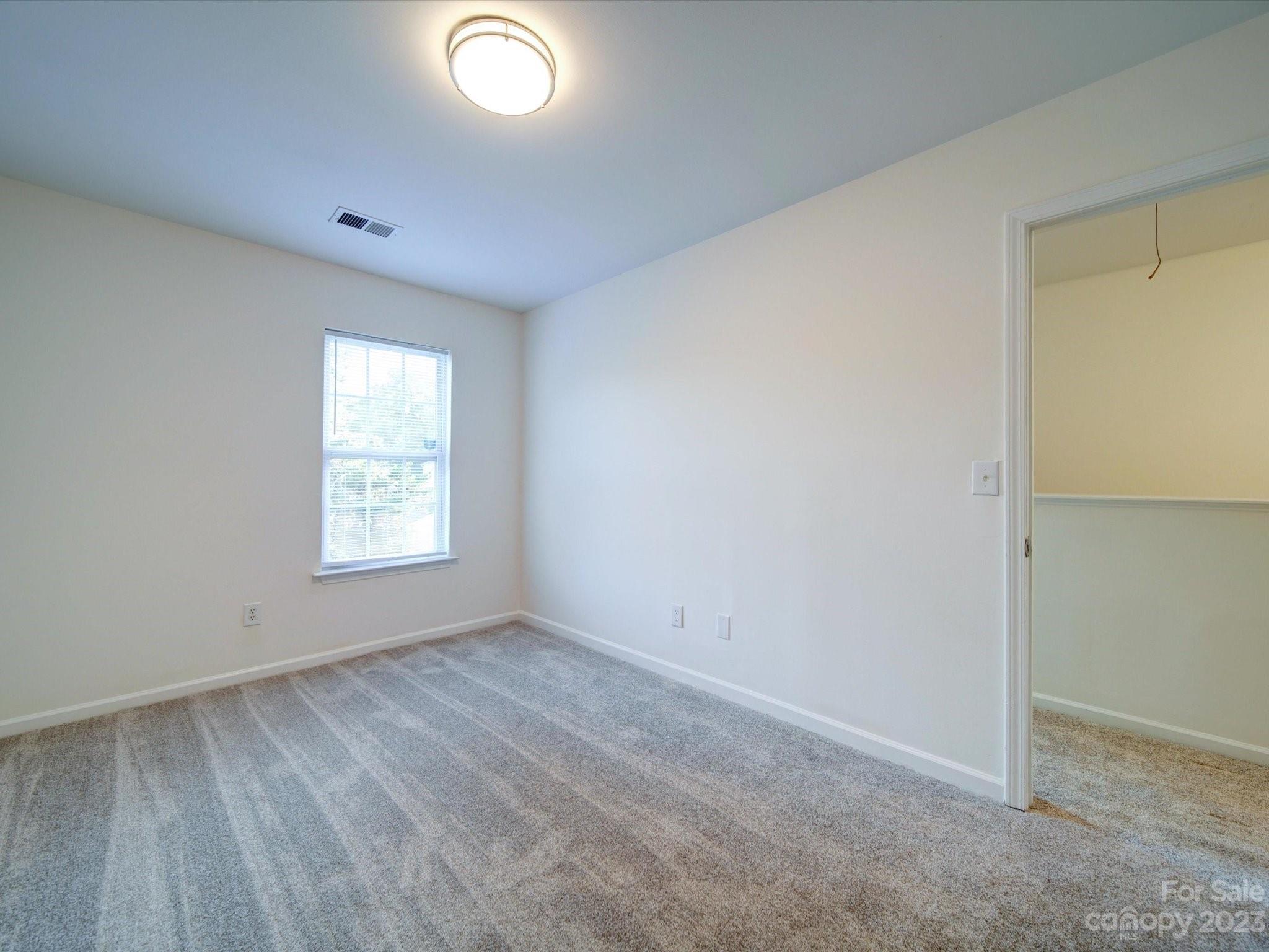 925 Key Street Charlotte, NC 28208 - Photo 30 of 41 an empty room with wooden floor and windows