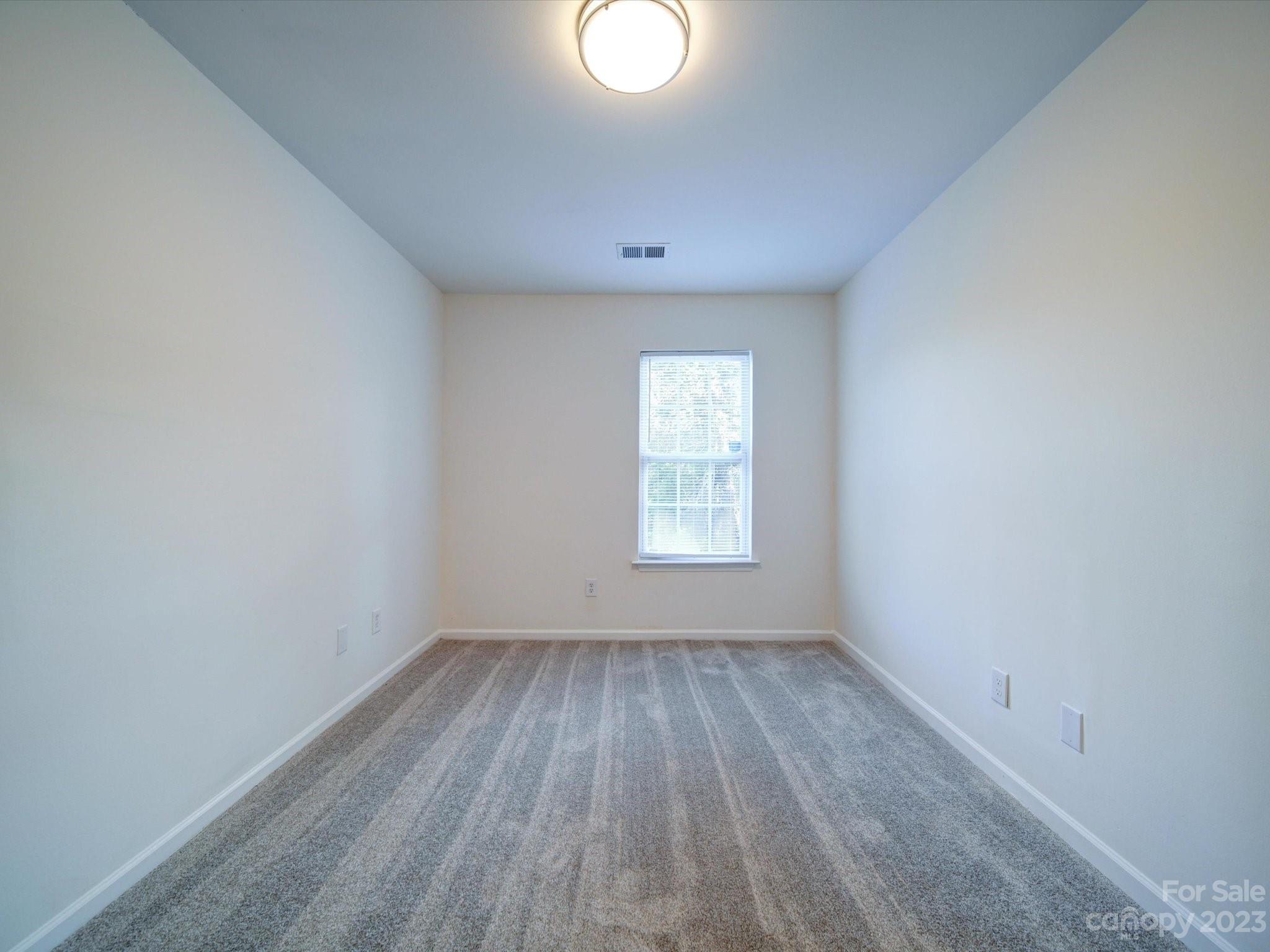 925 Key Street Charlotte, NC 28208 - Photo 32 of 41 an empty room with wooden floor and windows