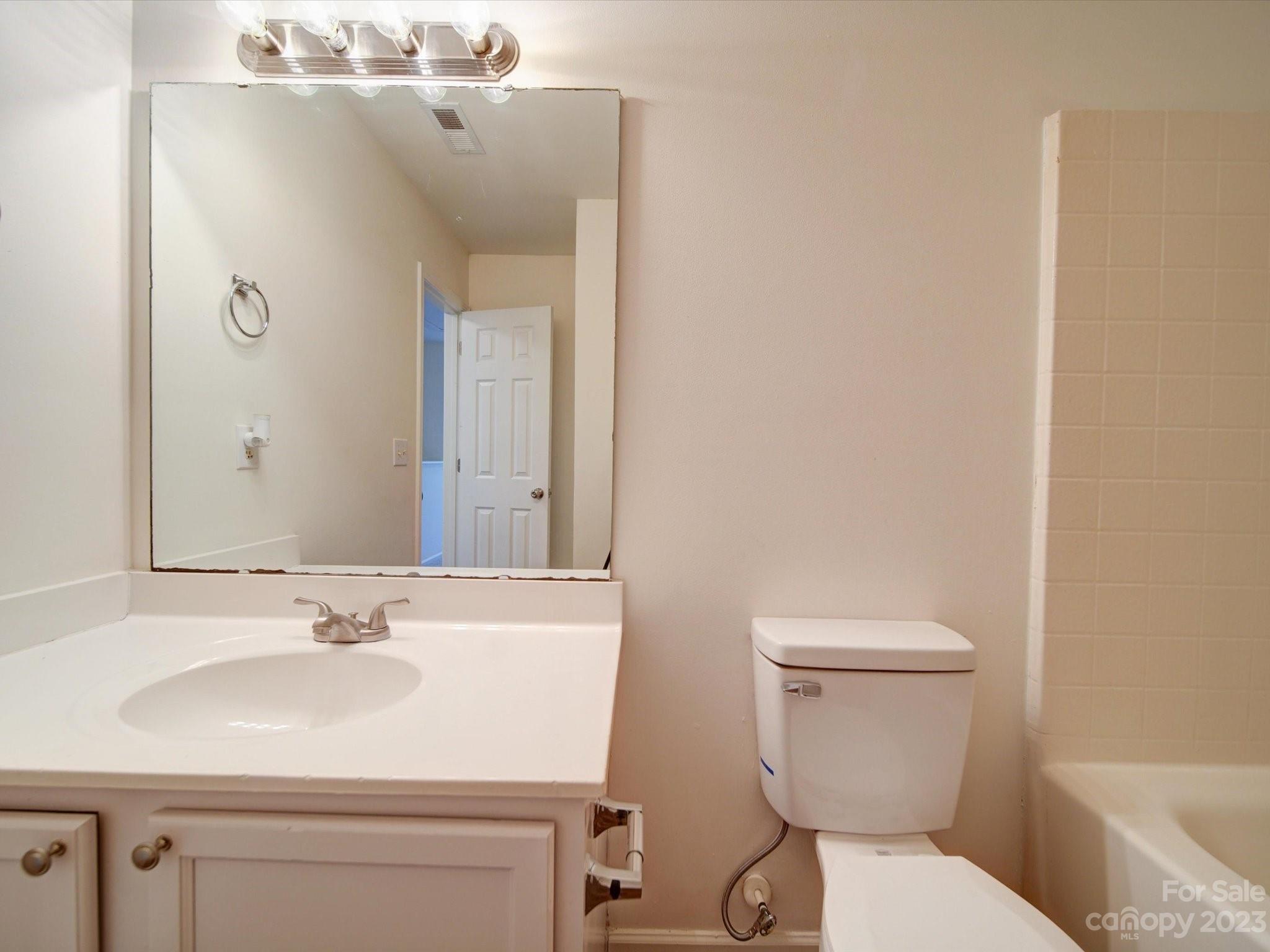 925 Key Street Charlotte, NC 28208 - Photo 36 of 41 a bathroom with a sink toilet and mirror
