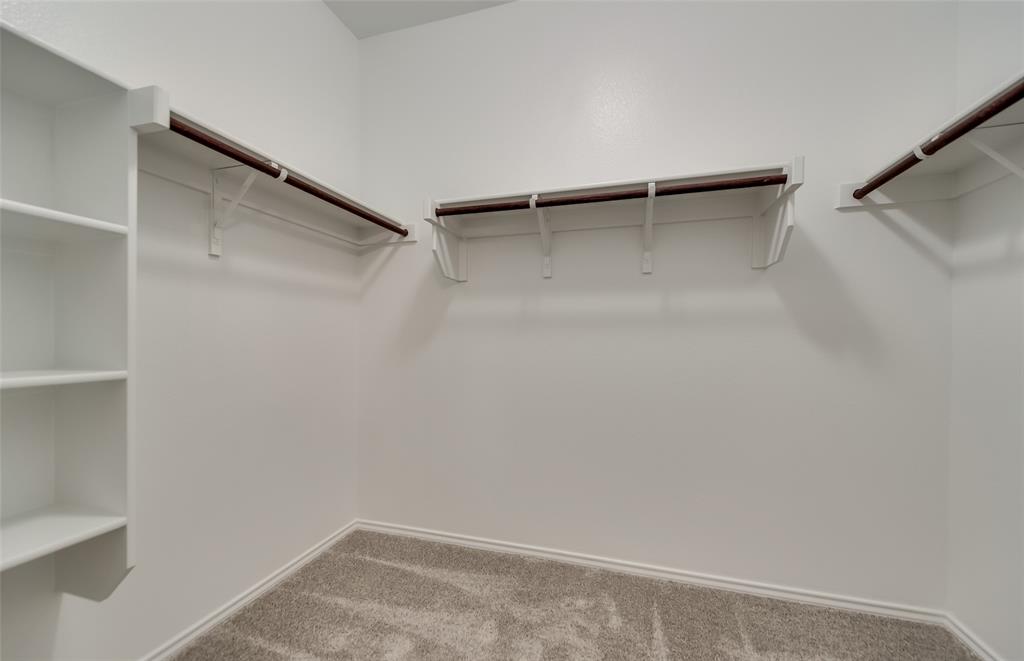 816 Shire Avenue Haslet, TX 76052 - Photo 19 of 23 a view of walk in closet with empty racks