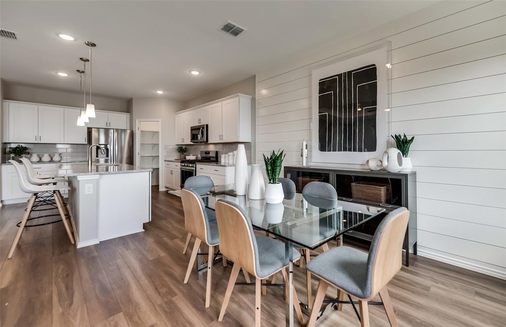 816 Shire Avenue Haslet, TX 76052 - Photo 6 of 23 a kitchen with stainless steel appliances kitchen island granite countertop a dining table chairs and sink