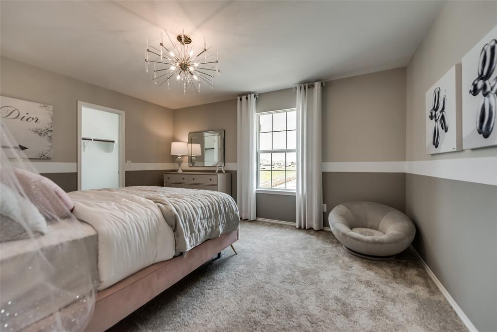 816 Shire Avenue Haslet, TX 76052 - Photo 7 of 23 a spacious bedroom with a bed and a chandelier