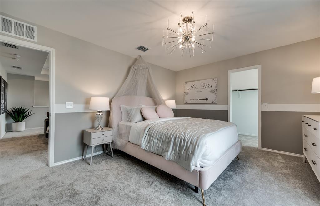 816 Shire Avenue Haslet, TX 76052 - Photo 8 of 23 a bedroom with a bed and a chandelier