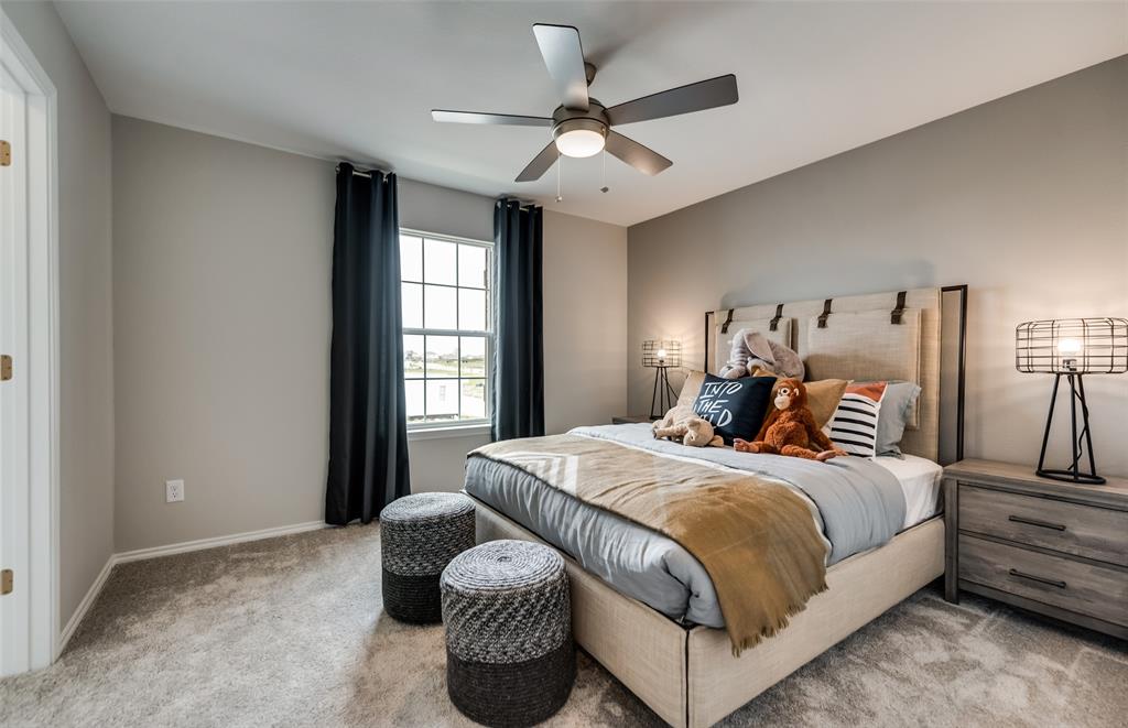 816 Shire Avenue Haslet, TX 76052 - Photo 9 of 23 a bedroom with a large bed and a chandelier