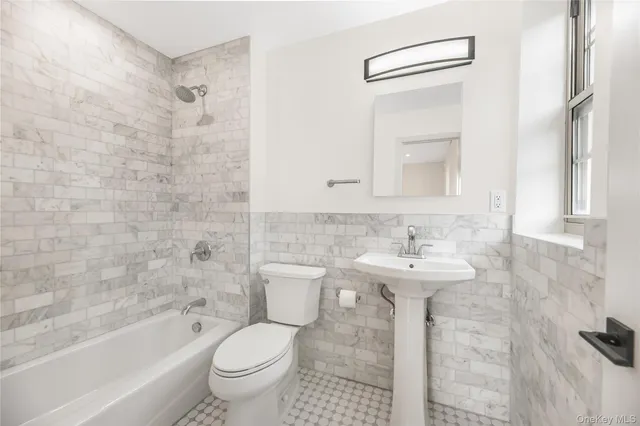 a bathroom with a sink a toilet and a bathtub