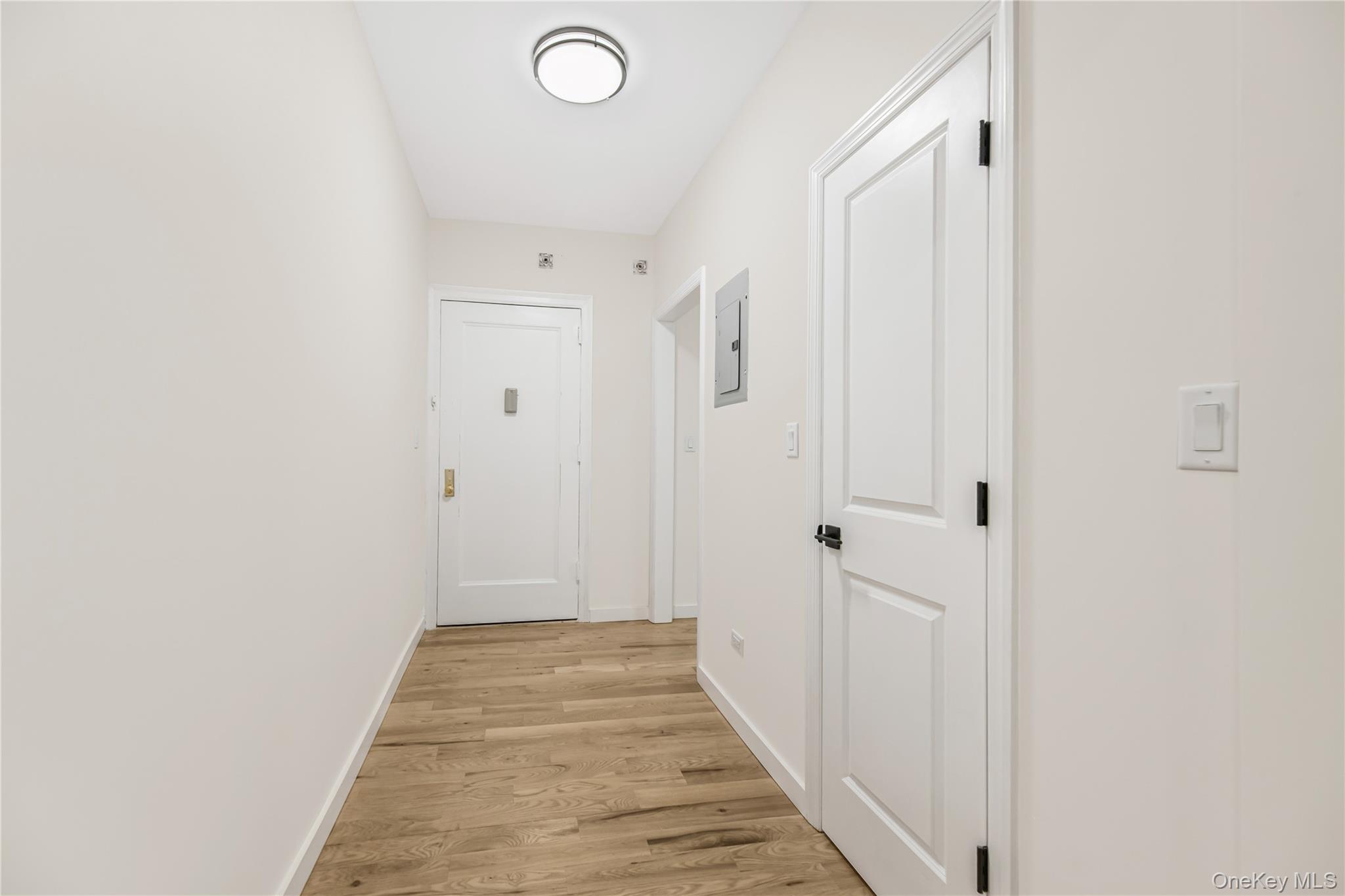 4 Park Lane, Unit 4H Mount Vernon, NY 10552 - Photo 6 of 22 a view of a hallway with wooden floor and a bathroom