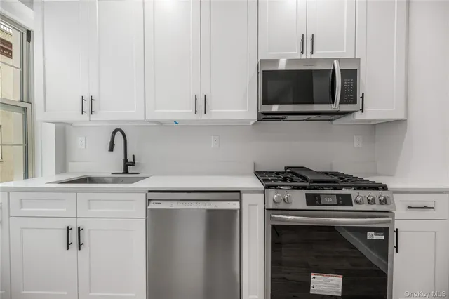 a kitchen with a stove and a microwave