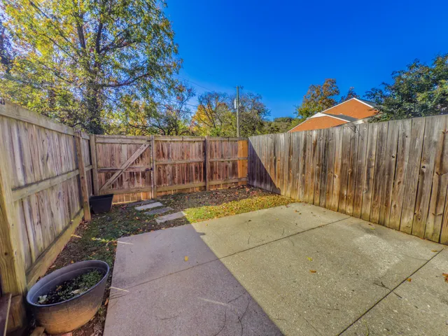 a view of a backyard with wooden fence