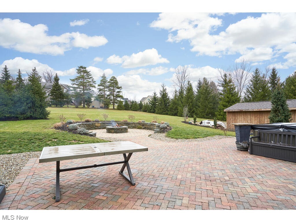 11530 Girdled Road Painesville, OH 44077 - Photo 21 of 32 View of terrace featuring a hot tub and a fire pit