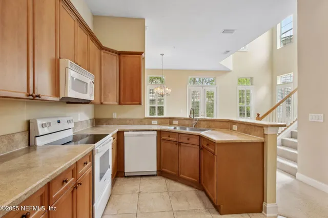 a kitchen with stainless steel appliances granite countertop a sink and cabinets