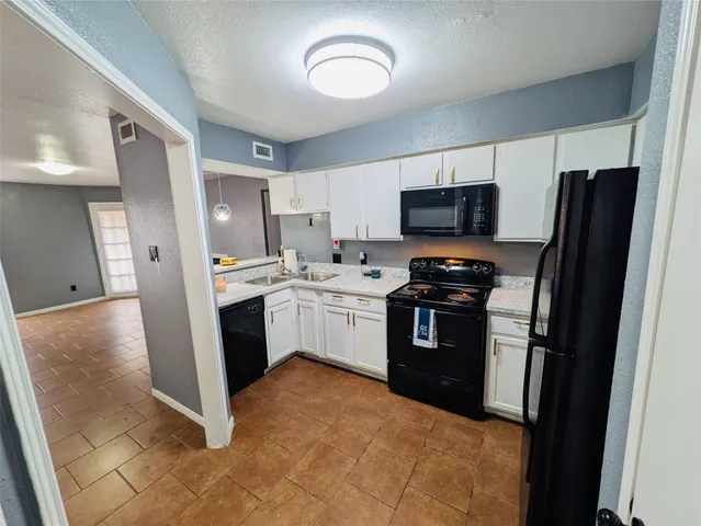 a kitchen with a refrigerator stove and microwave