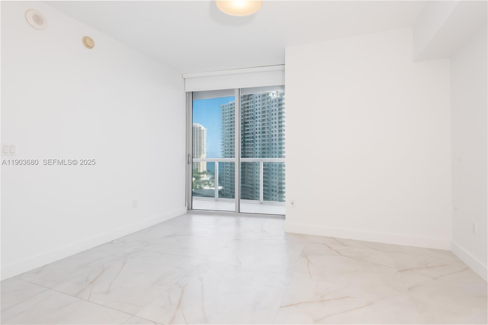 465 Brickell Avenue, Unit 1705 Miami, FL 33131 - Photo 14 of 34 a view of an empty room with a window