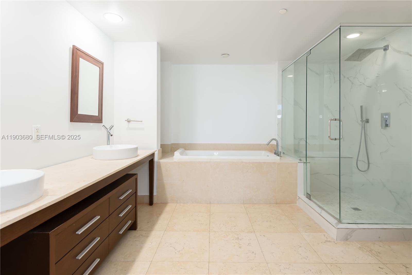 465 Brickell Avenue, Unit 1705 Miami, FL 33131 - Photo 9 of 34 a spacious bathroom with a shower sink and mirror
