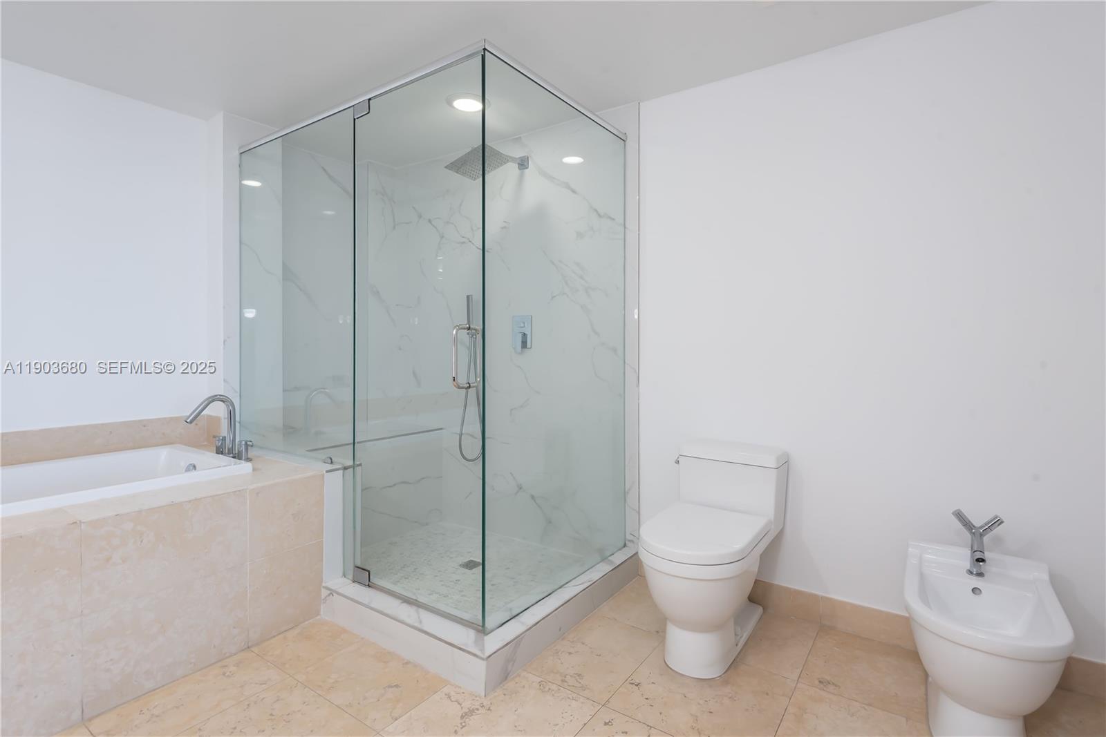 465 Brickell Avenue, Unit 1705 Miami, FL 33131 - Photo 10 of 34 a bathroom with a toilet a sink and shower