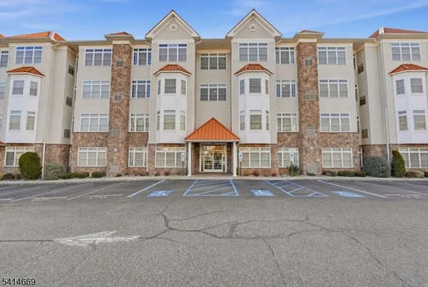 a front view of a residential apartment building with a yard