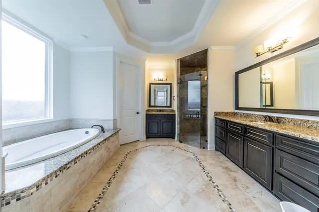 a bedroom with a bed a desk and a chandelier