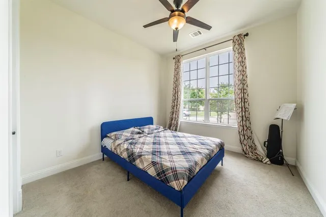 a bathroom with a sink a toilet and a large mirror