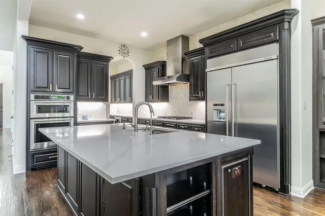 a kitchen with kitchen island a counter top space appliances and cabinets