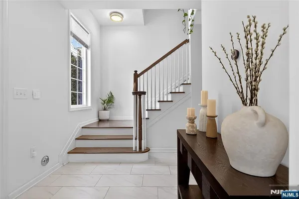 a view of entryway and hall with wooden floor