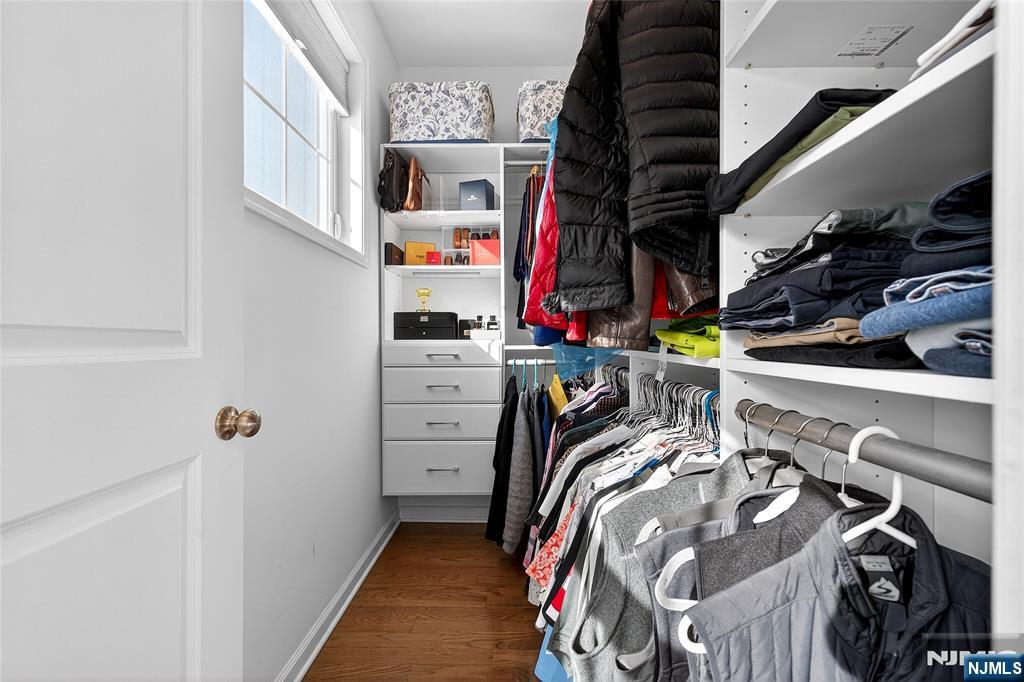 165 Roosevelt Drive Wood-Ridge, NJ 07075 - Photo 33 of 50 a view of walk in closet with clothes and shoes