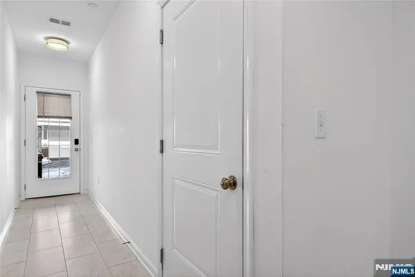 a view of an entryway with a hallway