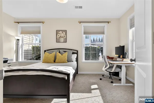 a bedroom with a bed and a desk