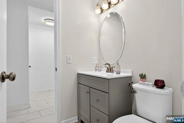 a bathroom with a toilet a sink and mirror