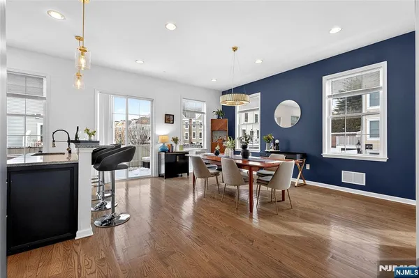 a living room with furniture a dining table and chairs