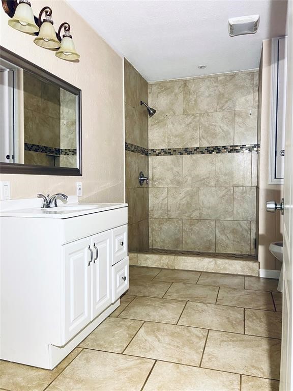 88 Gazebo Street, Unit C Huntsville, TX 77340 - Photo 6 of 12 a bathroom with a double vanity sink mirror and shower