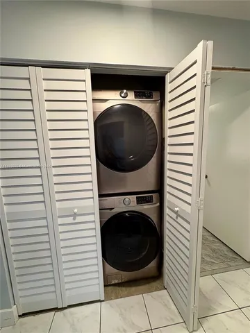 a view of a hallway with washer and dryer
