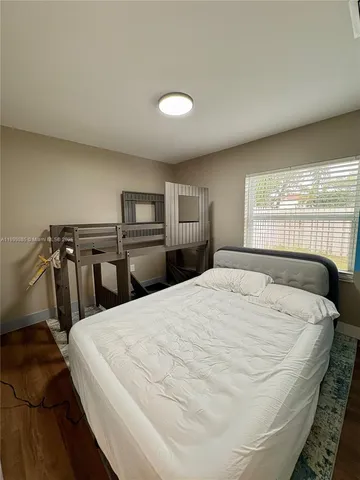 a large white bed in a white room