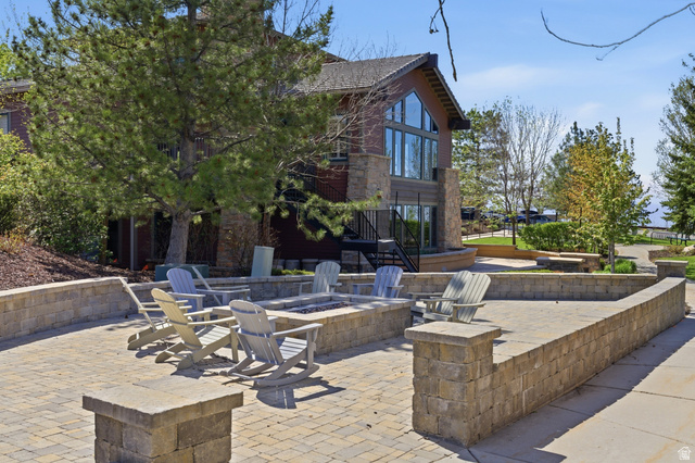 2007 Fielding Hill Lane Draper, UT 84020 - Photo 68 of 83 Paver patio with an integrated fire pit, surrounded by low stone retaining walls