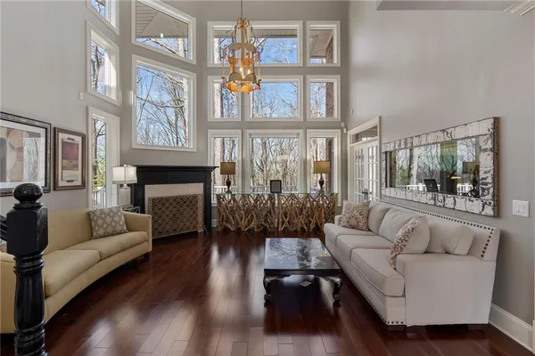 a living room with furniture a fireplace and a large window