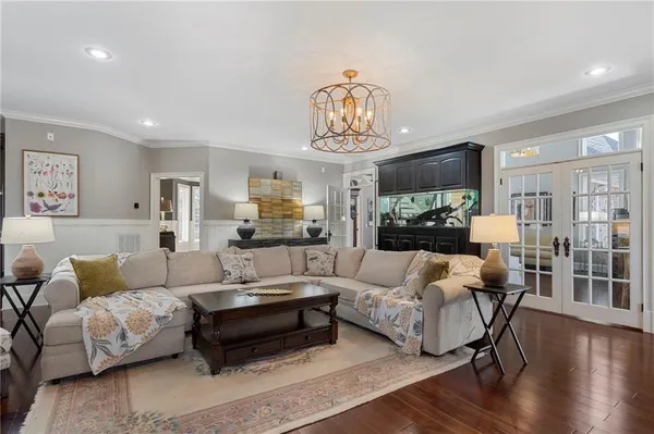a living room with furniture and a chandelier