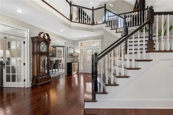 a view of entryway and hall with wooden floor