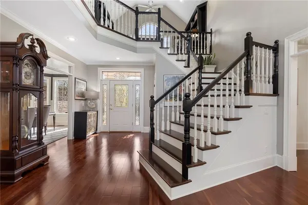 a view of entryway and hall with wooden floor