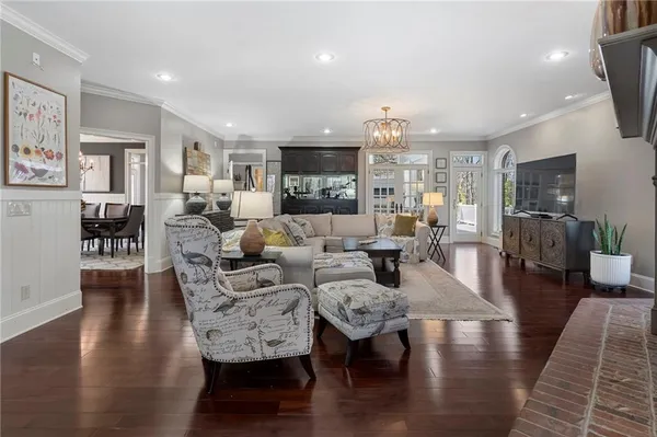 a living room with fireplace furniture and a wooden floor