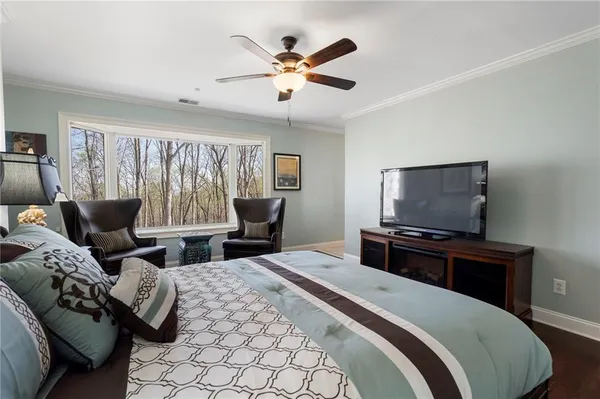 a bedroom with a bed and a television