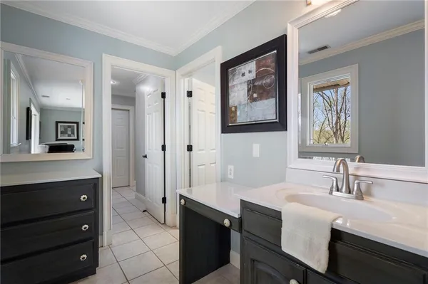 a bathroom with a sink vanity and a mirror