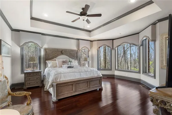 a bedroom with a bed and a chandelier