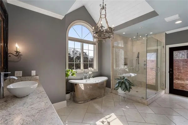 a living room with patio furniture and a chandelier