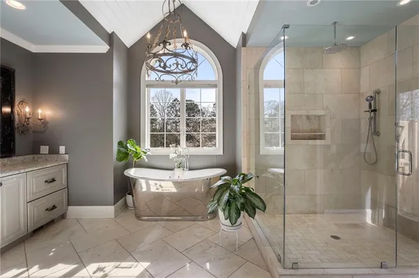 a spacious bathroom with a bathtub and a shower