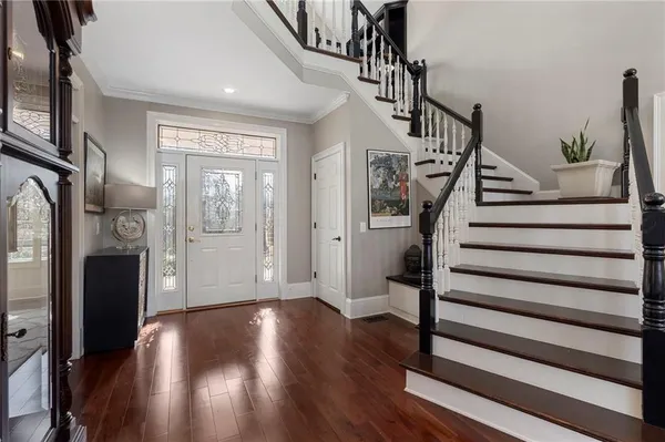 a view of entryway with wooden floor and stairs