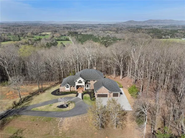 a view of a house with a yard and mountain view