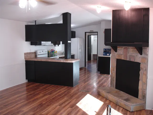 a kitchen with stainless steel appliances kitchen island granite countertop a sink and a microwave