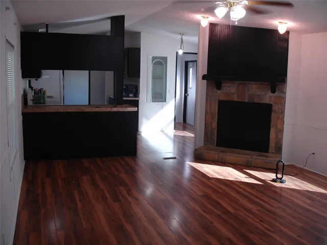 a living room with a fireplace and a flat screen tv