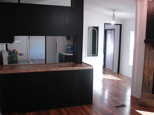 a view of a kitchen counter space and wooden floor